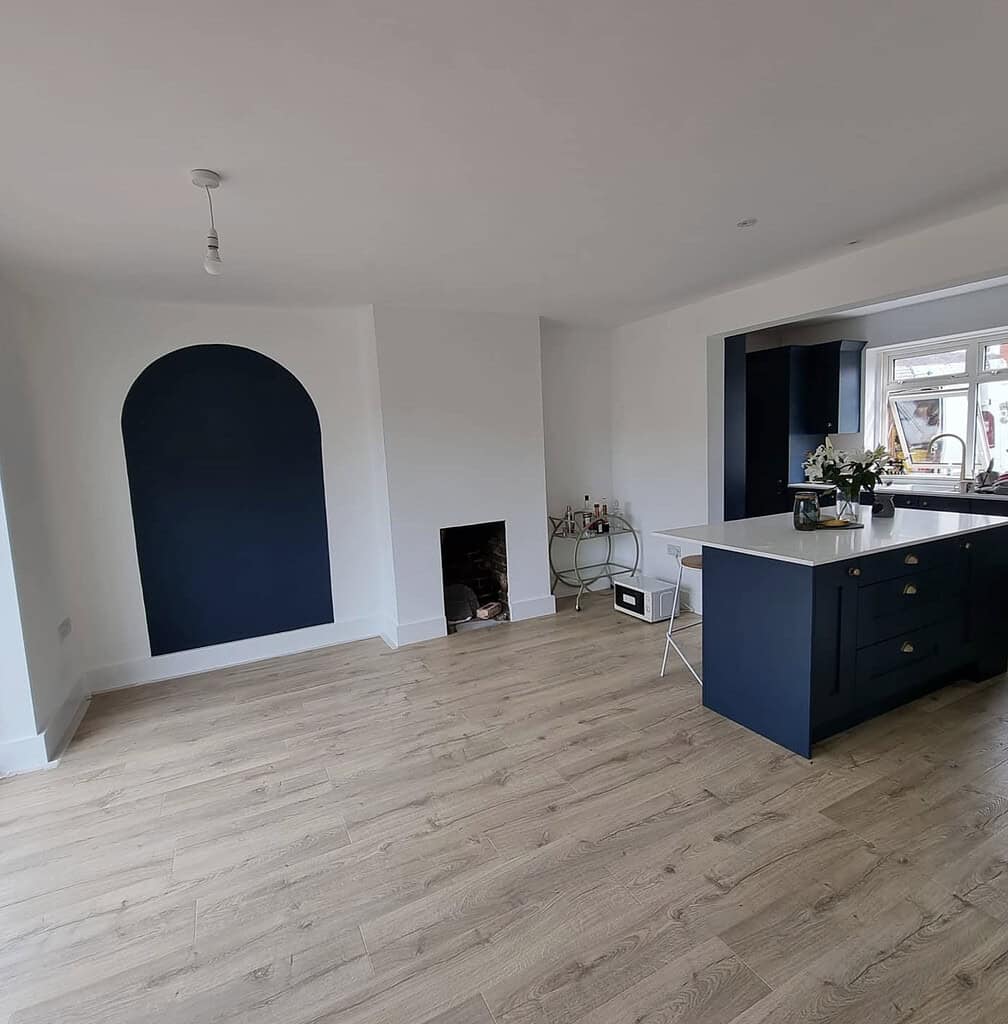 Additional view of a blue and white professionally decorated kitchen and dining area with modern finishes