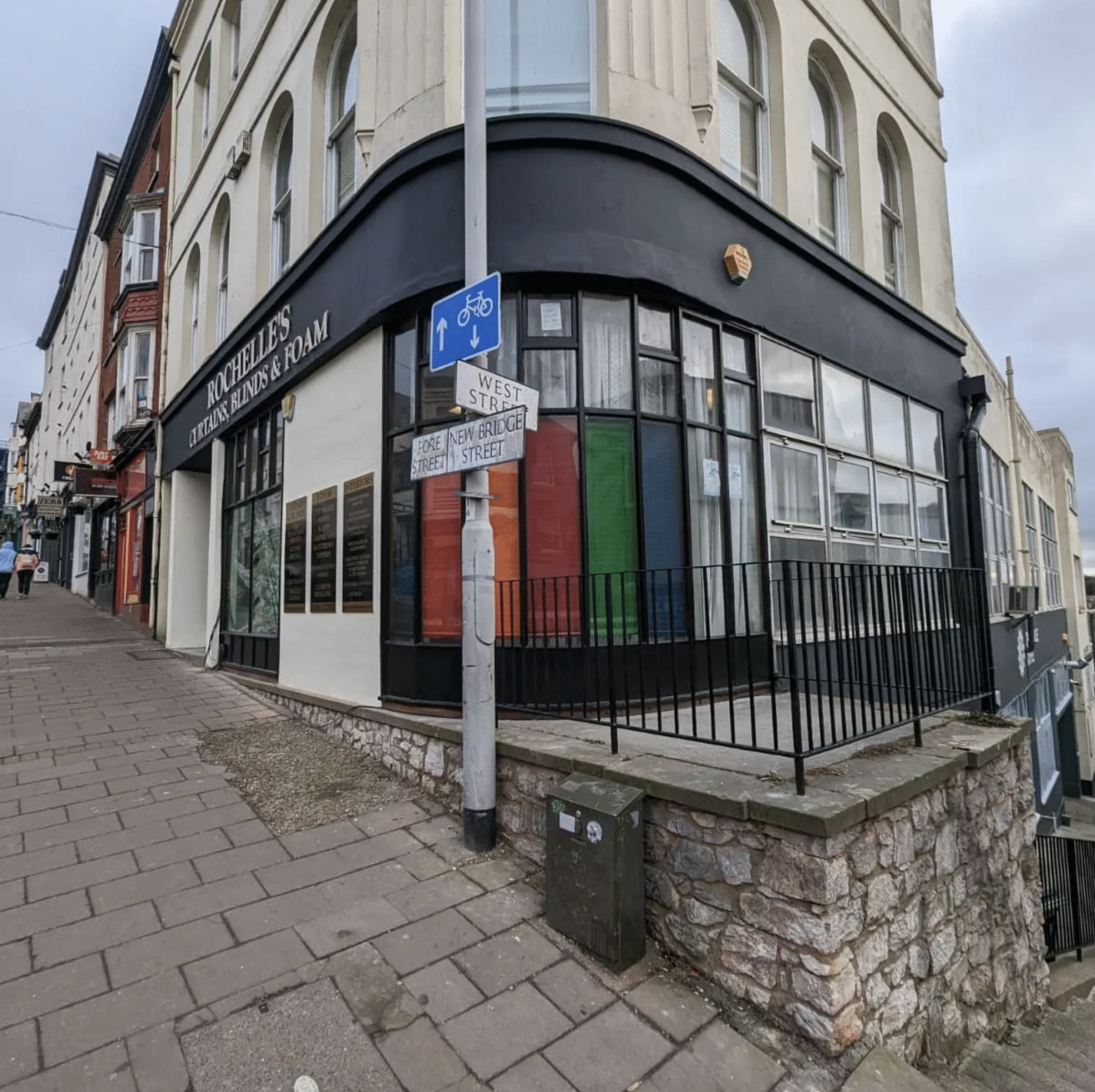 Side-angle street view of a freshly painted shop exterior after commercial redecoration in Exeter