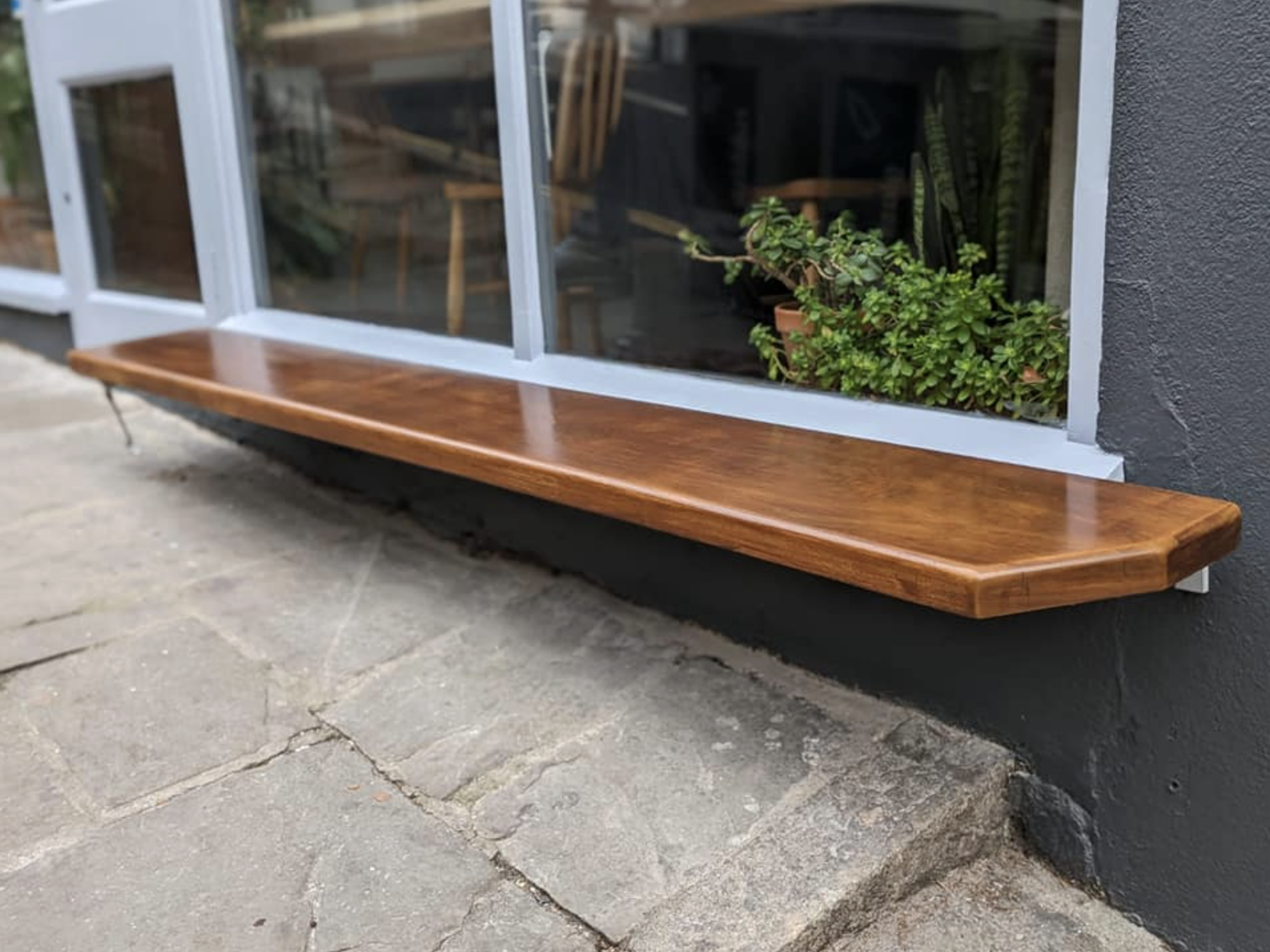 Freshly painted small bench outside a coffee shop as part of an exterior decorating project in Exeter