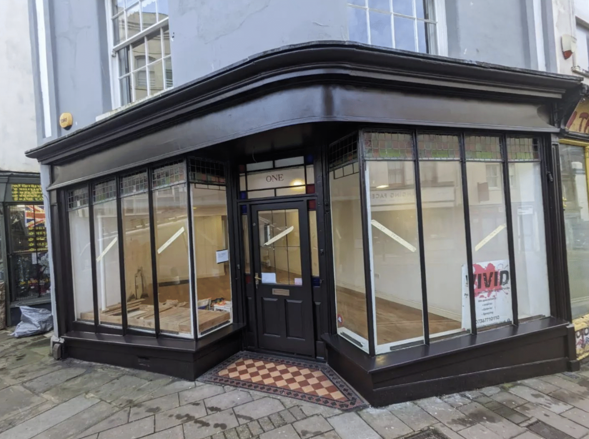 Front view of a freshly painted shopfront with newly decorated doorframe and exterior window frames in Exeter