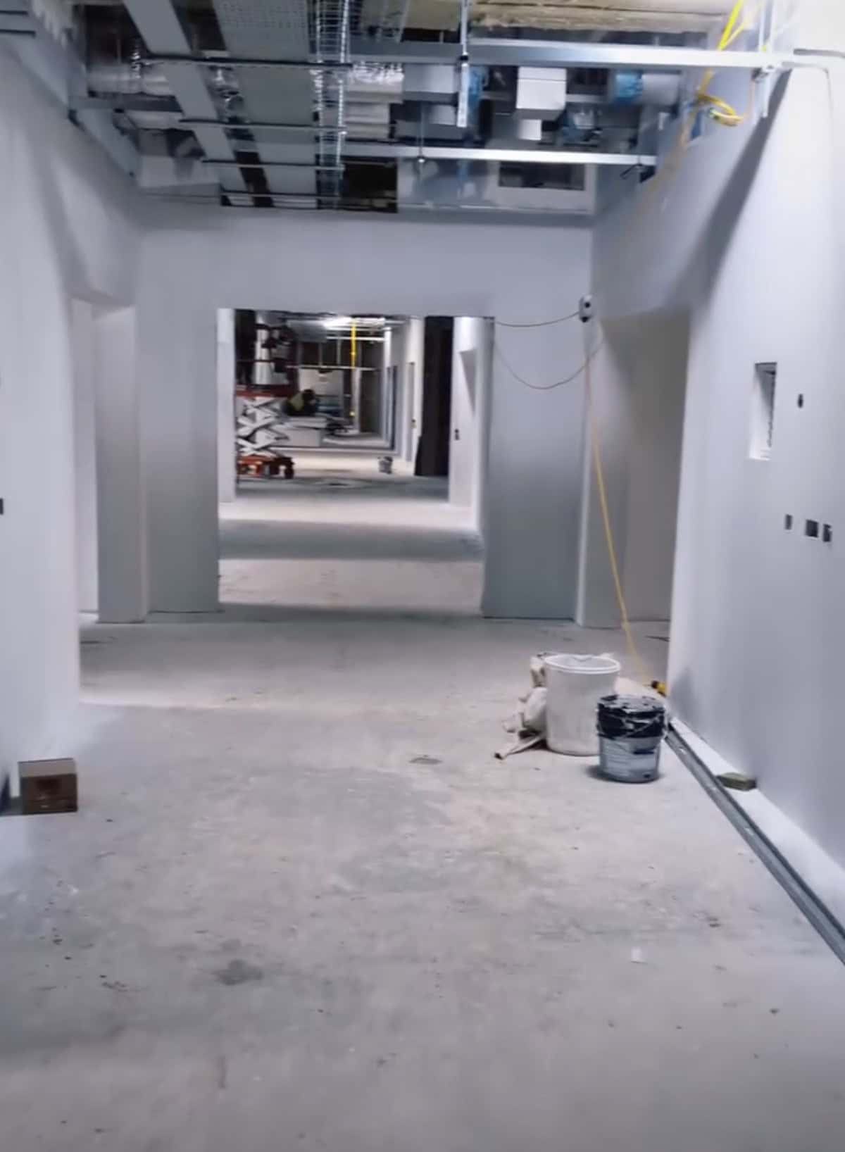 Industrial hallway mid-way through painting and decorating with surfaces prepped and partially coated