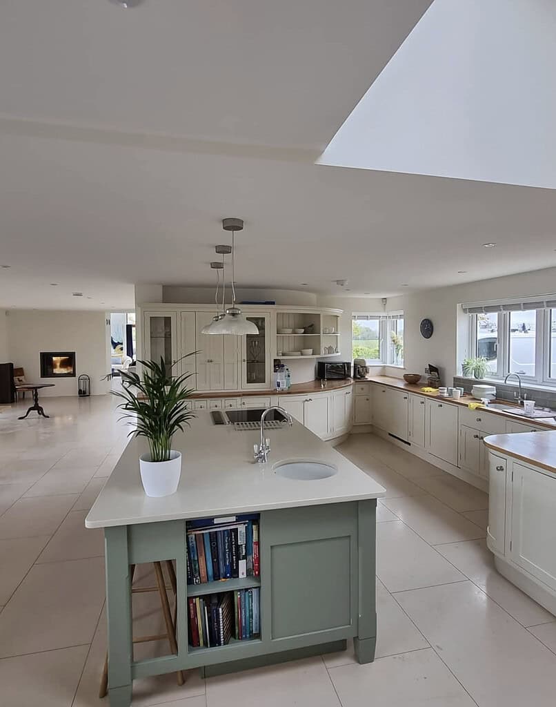 View from the kitchen doorway showing the freshly painted kitchen island and open-plan living room beyond