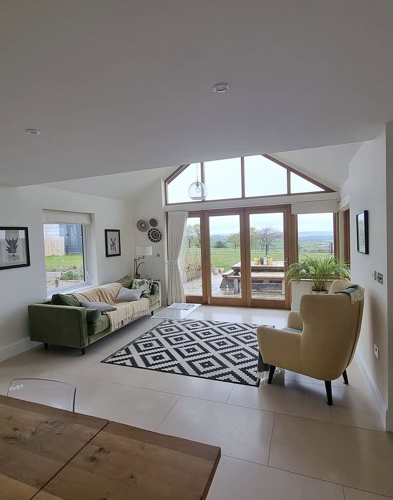 Decorated lounge beside kitchen featuring fresh paintwork and doors opening to the garden