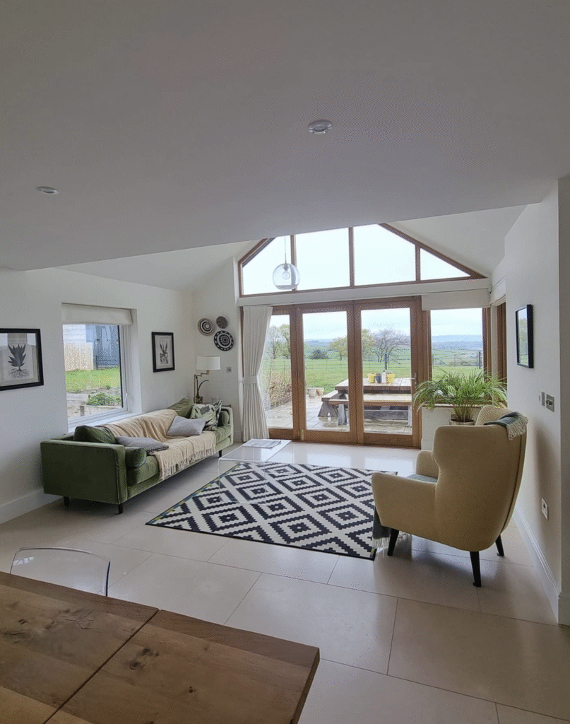 Decorated lounge beside kitchen featuring fresh paintwork and doors opening to the garden