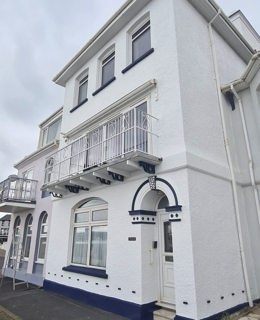 Angled side view of the freshly painted front elevation of a residential house